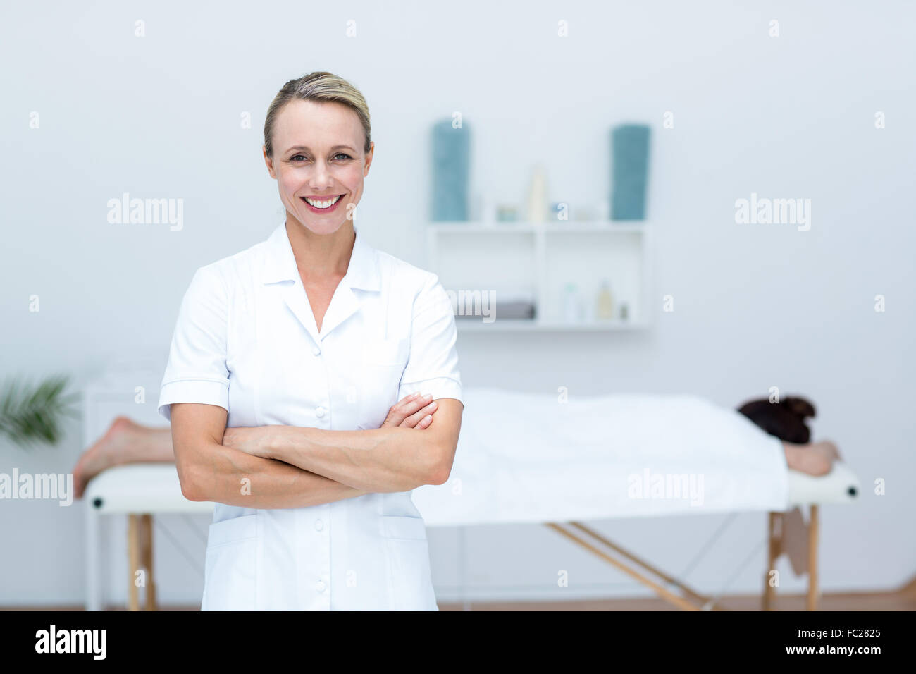 Physiotherapist smiling at camera arms crossed Stock Photo