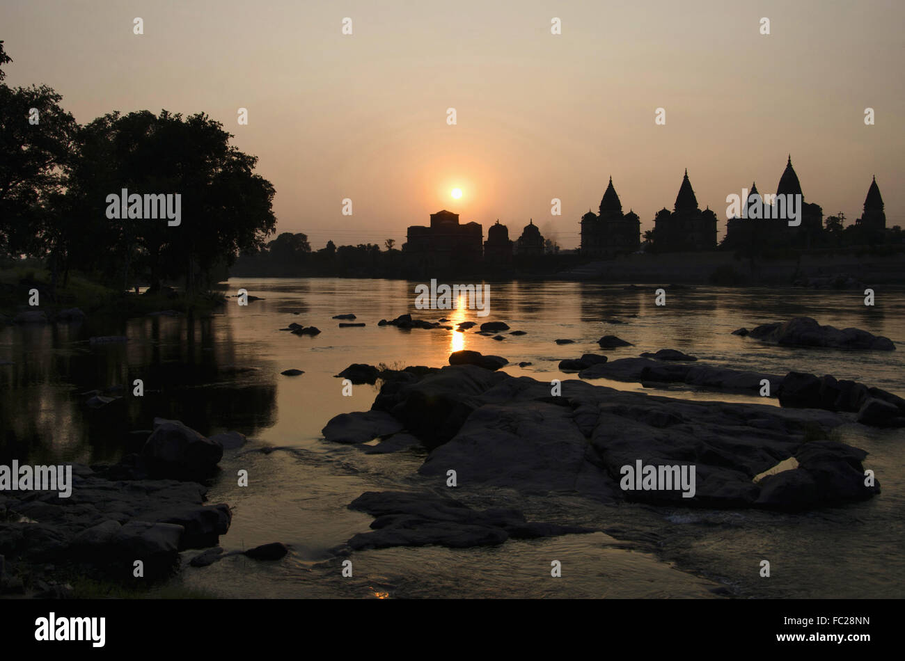 Sunset. silhouette of chatris on the bank of Betwa river at Orchha.Madhya Pradesh. India Stock Photo