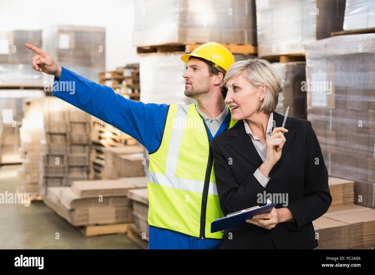 Warehouse worker and his manager working together Stock Photo - Alamy