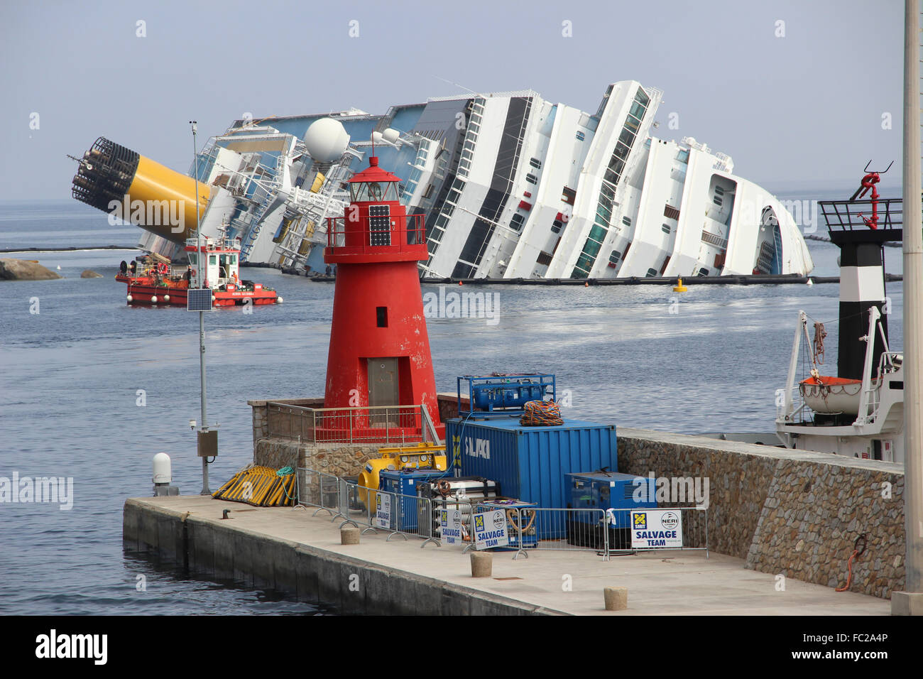 Damaged cruise ship Costa Concordia laying in Giglio Porto harbour, Giglio, Tuscany, Italy Stock Photo