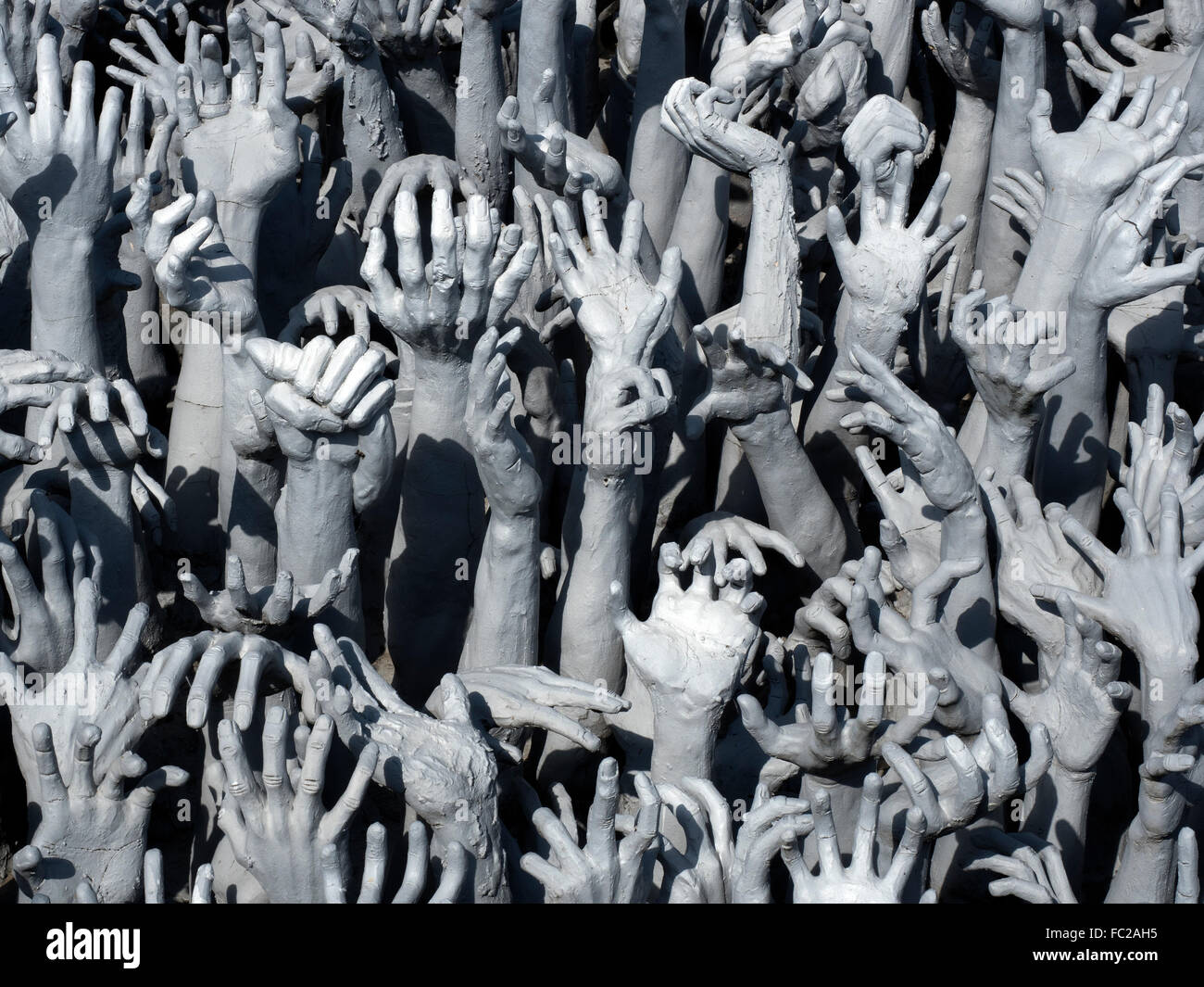 Representation of hell, hands pleading for help, entrance to white temple, Wat Rong Khun, Chiang Rai, Thailand Stock Photo
