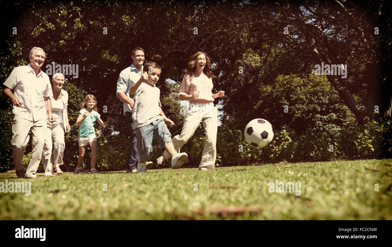 Cheerful multi generation family playing football Stock Photo - Alamy