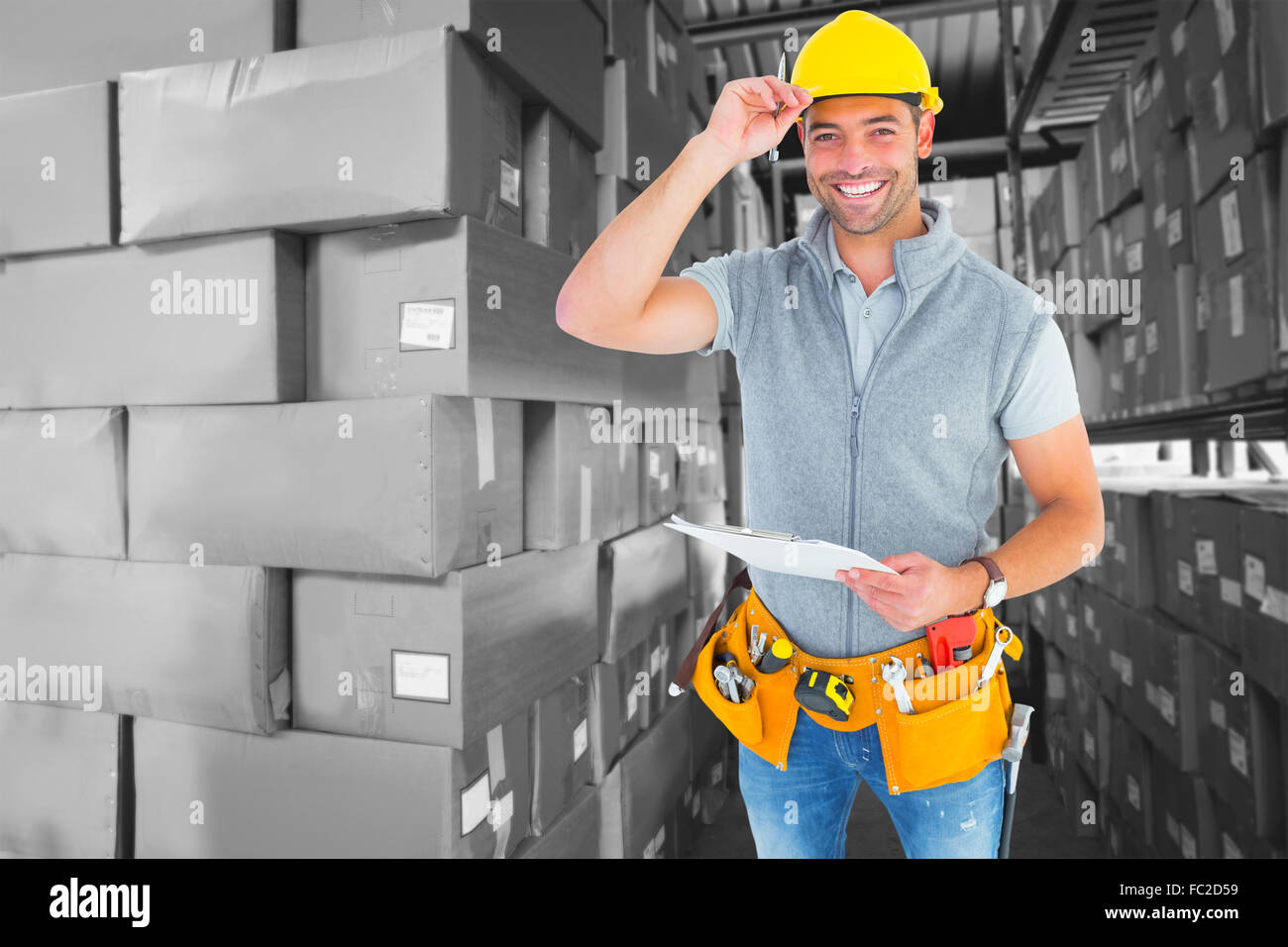 Composite image of portrait of smiling manual worker holding clipboard Stock Photo