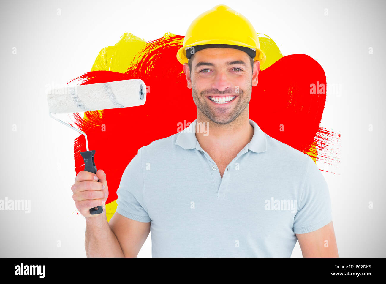 Composite image of portrait of manual worker holding paint roller Stock Photo