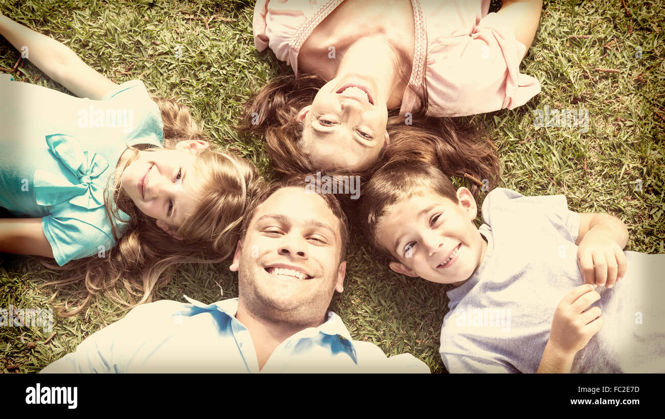 Happy family lying on the grass in a circle Stock Photo - Alamy