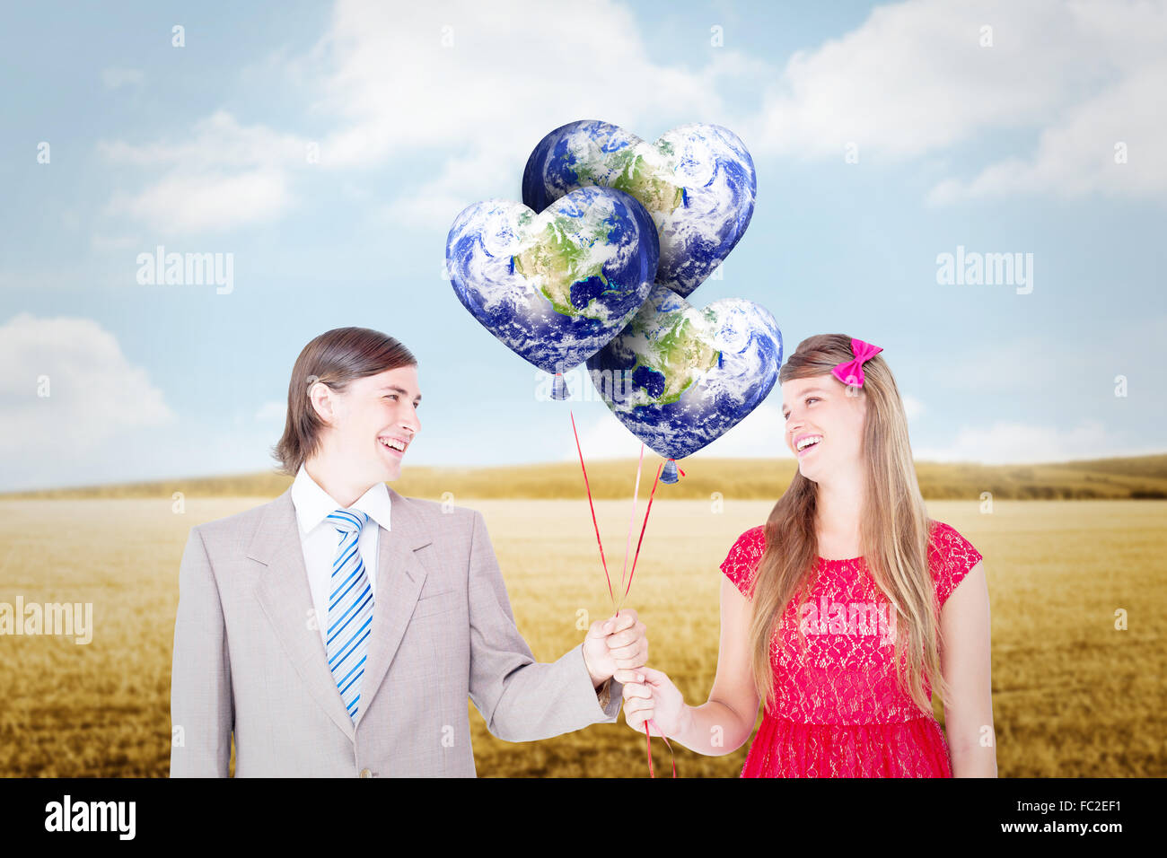 Composite image of smiling geeky couple holding red balloons Stock ...
