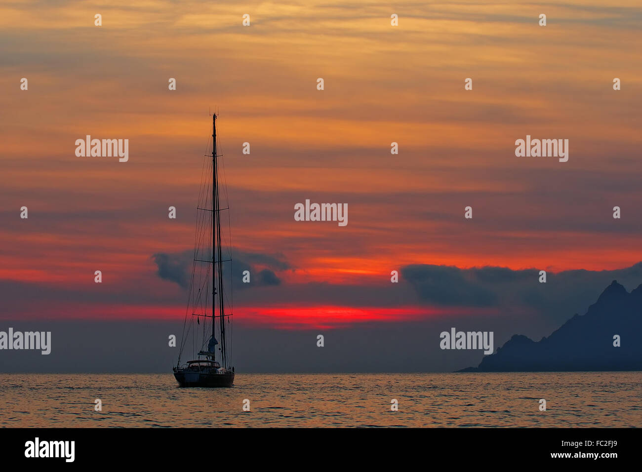 Sailing yacht in the sunset - Corsica Stock Photo