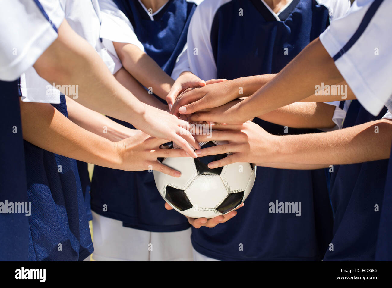 Pretty football players putting hands together Stock Photo Alamy