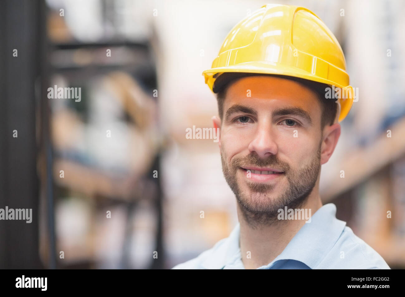 Close up of worker wearing hard hat in warehouse Stock Photo