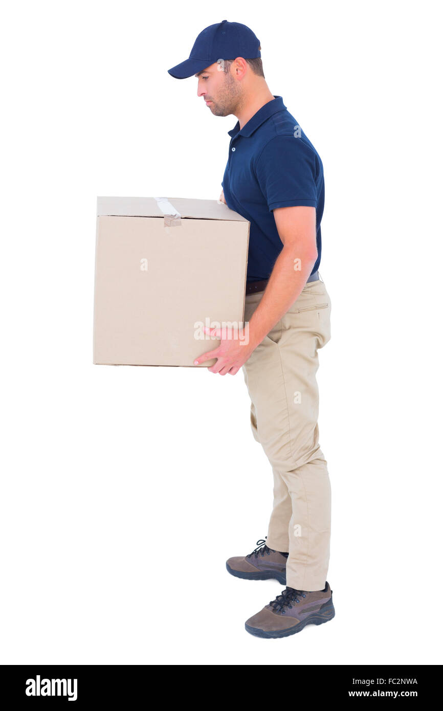 Side view of delivery man carrying cardboard box Stock Photo