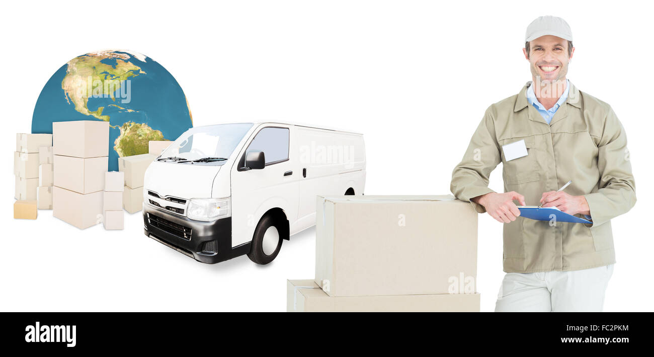 Composite image of happy delivery man writing on clipboard by cardboard boxes Stock Photo
