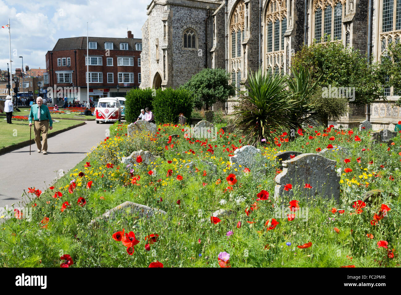 person walking in the churchyard  in the seaside resort of Cromer North Norfolk England Stock Photo