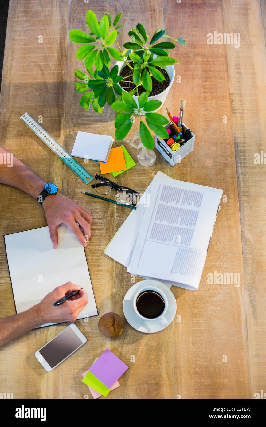 Businessman writing in notepad Stock Photo - Alamy