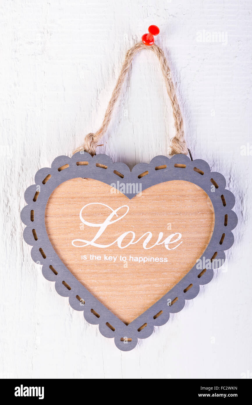 Heart shape frame on white wooden background. Love concept. Stock Photo