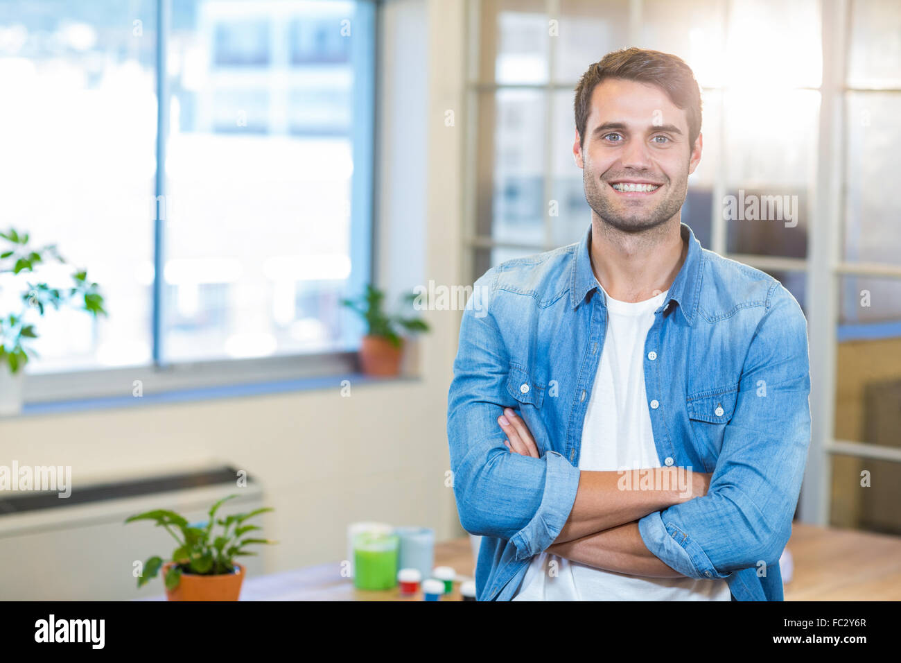 Casual businessman smiling at camera with arms crossed Stock Photo - Alamy