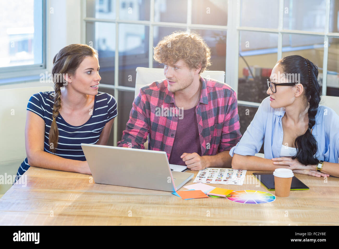 Partner Work Photo Smiling partners working together with photographs Stock Photo - Alamy