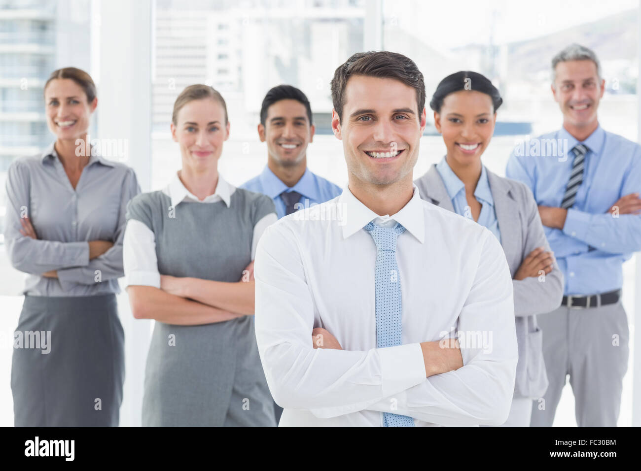 Business people looking at camera with arms crossed Stock Photo - Alamy