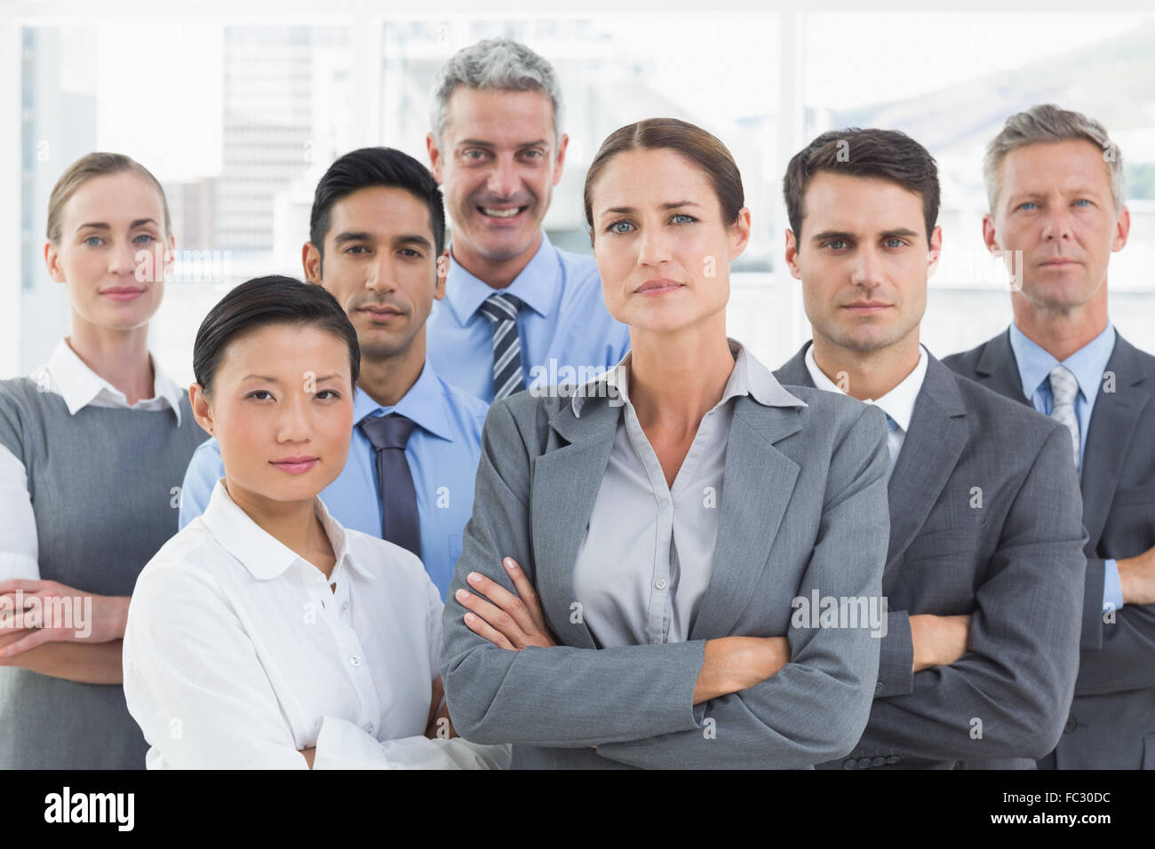 Business people looking at camera with arms crossed Stock Photo - Alamy