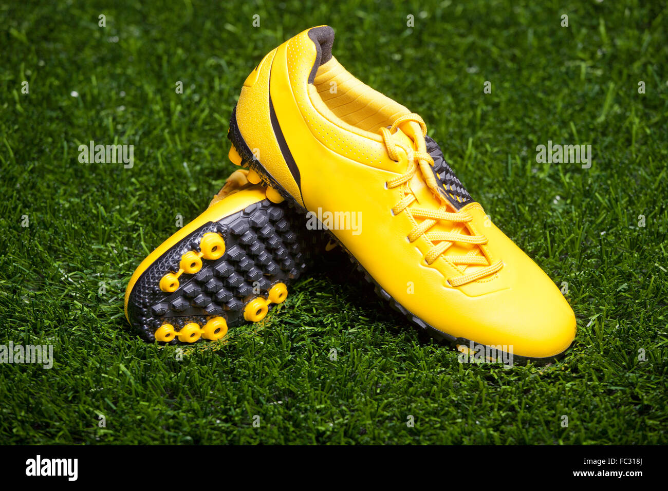 Pair of soccer shoes on grass field Stock Photo