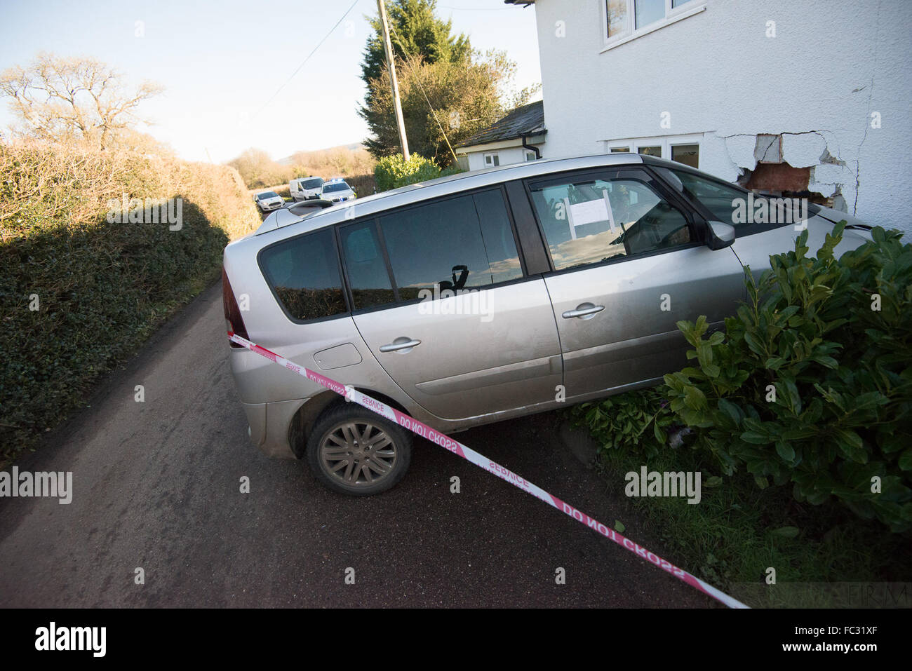 Ottery St Mary, Devon, UK. 20th January, 2016. Icy winter weather - causes dramatic vehicle collison - Near Ottery St mary, East Devon, UK.  Car Crashes into House - Fluxon, Ottery St Mary, Devon.    A Renault Scenic has come of the road at Fluxton, nr Ottery St Mary ,East Devon this morning, and crashed into the side of Apple cottage. Credit:  camerafirm/Alamy Live News Stock Photo