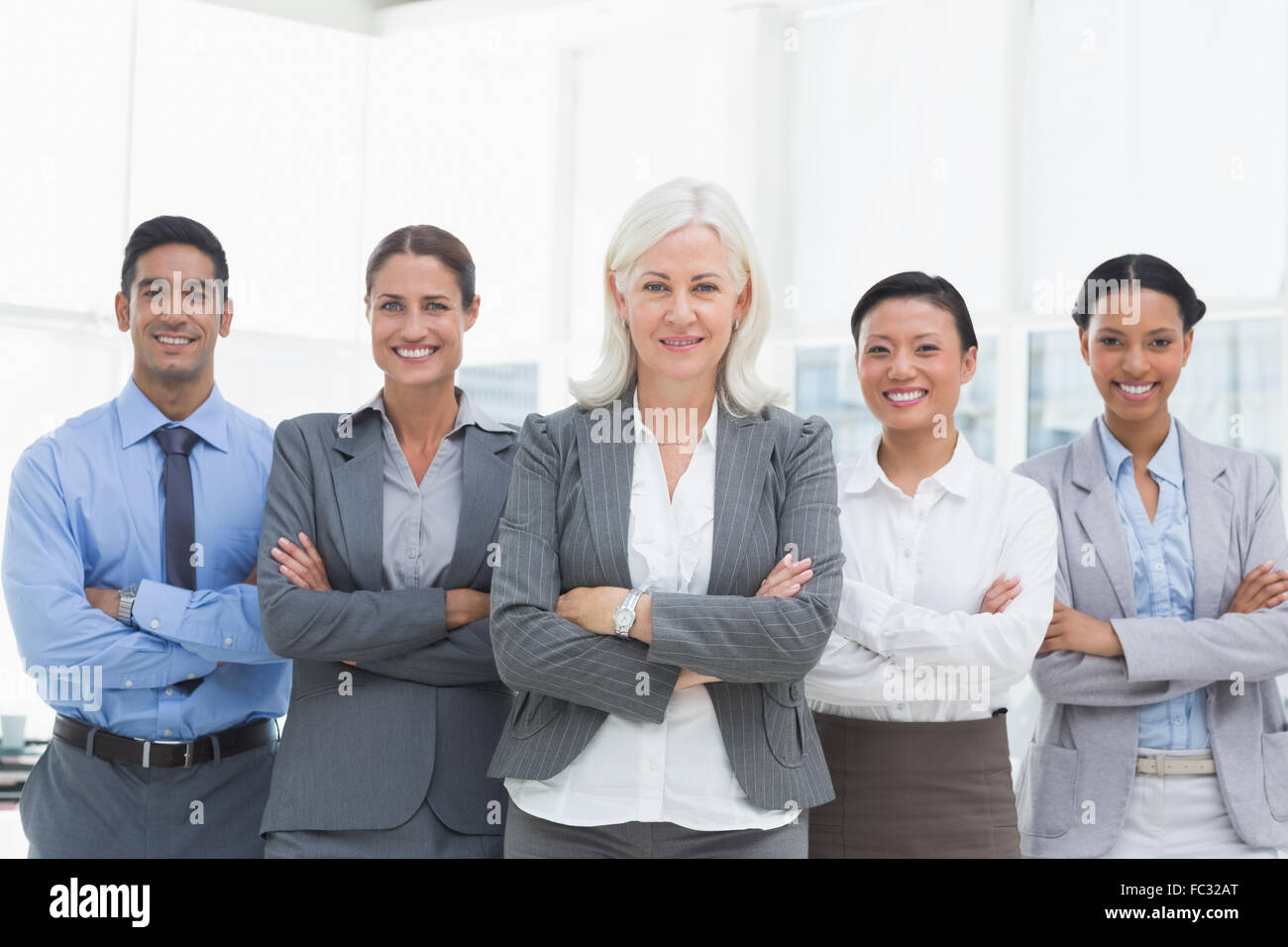 Business people with arms crossed smiling at camera Stock Photo - Alamy