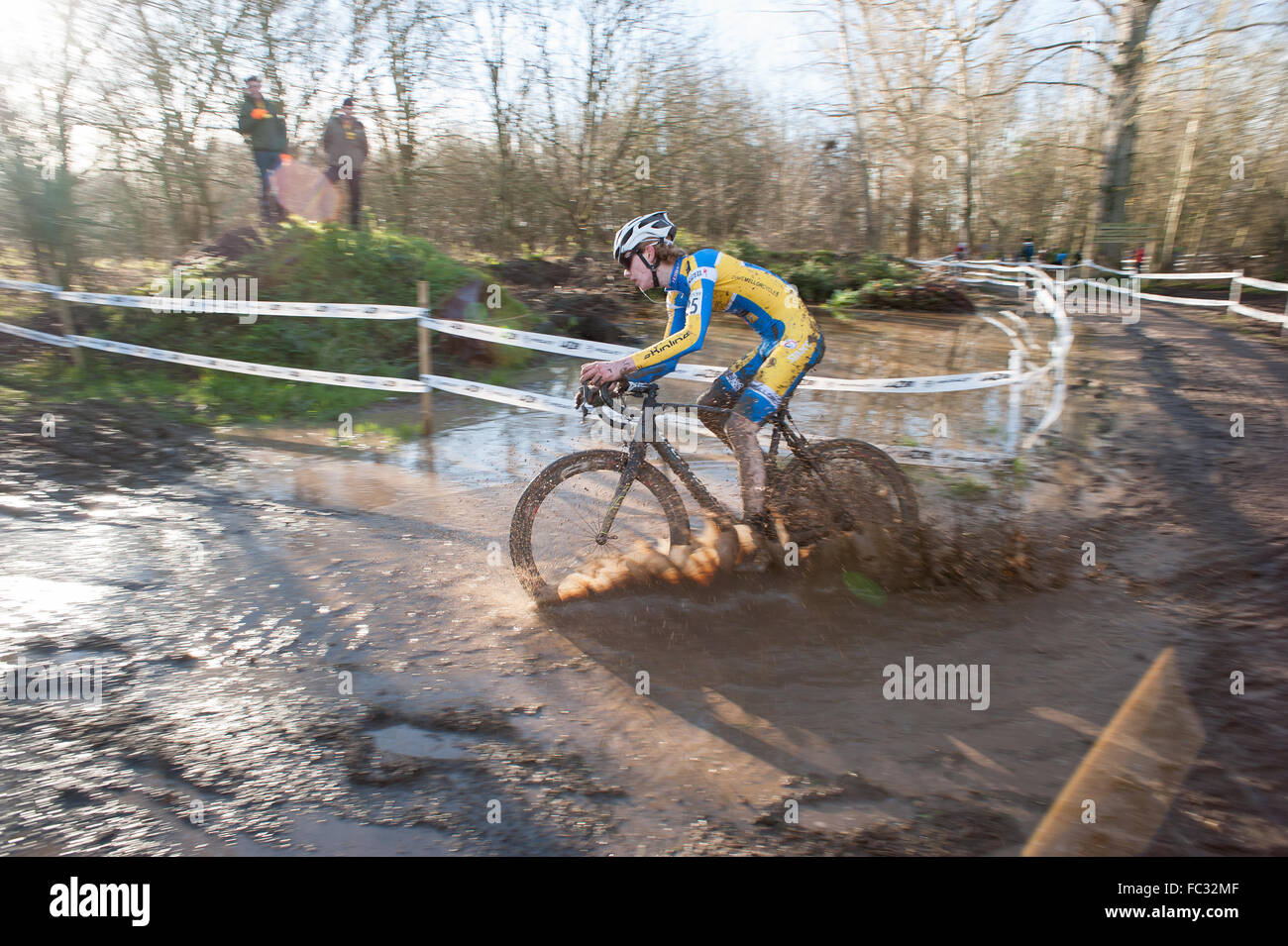 Cyclocross rider riding through water during a race Stock Photo