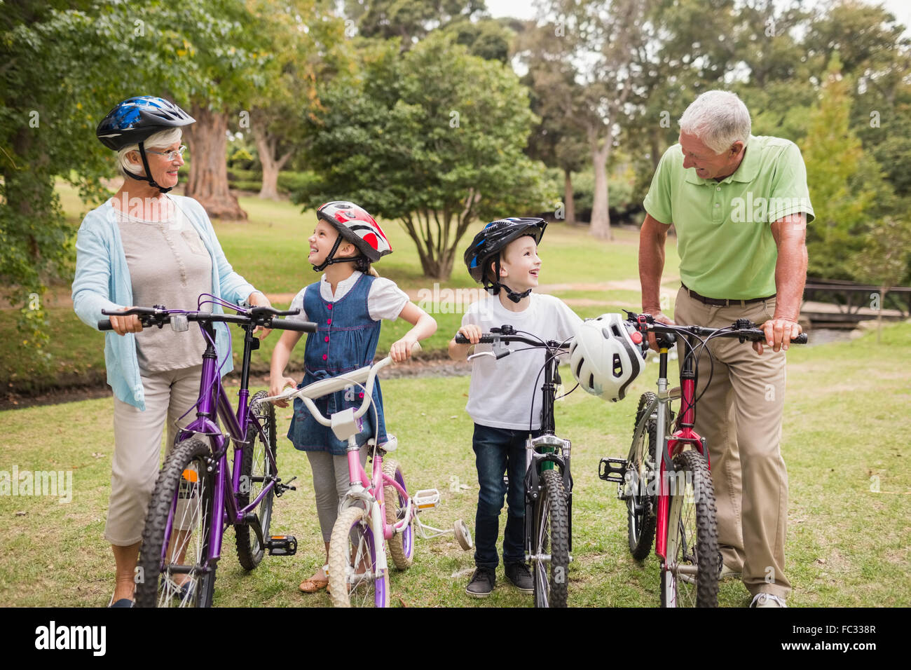 Happy grandparents with their grandchildren on their bike Stock Photo