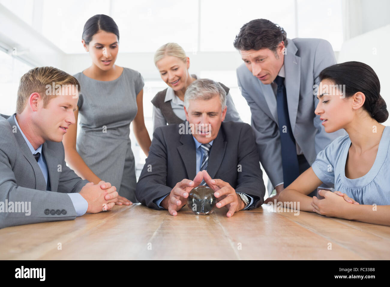 Businessman forecasting the future with his crystal ball Stock Photo ...