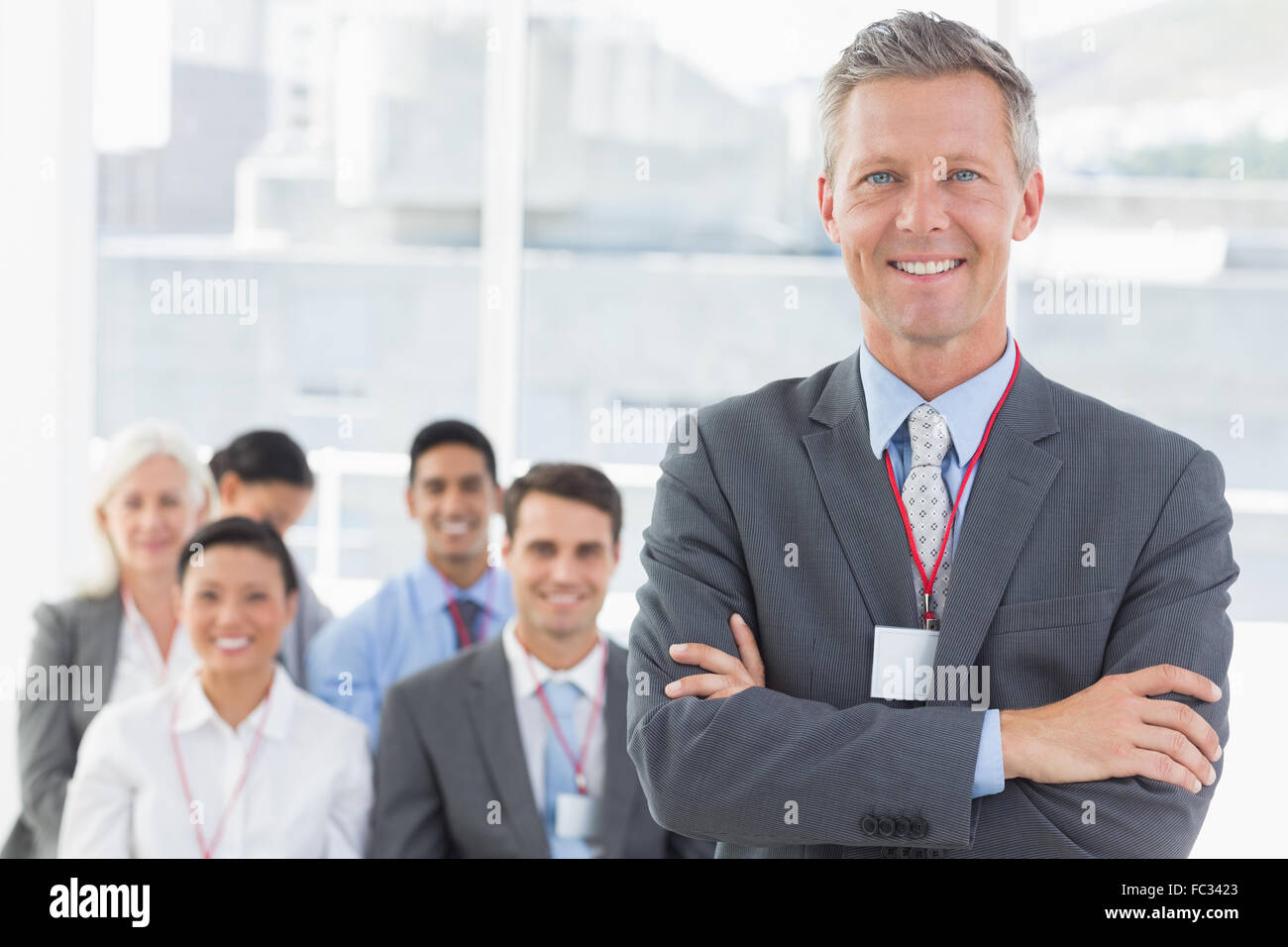 Business people looking at camera with arms crossed Stock Photo - Alamy