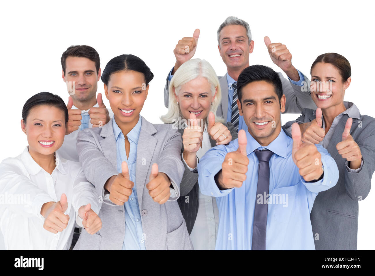 Happy business people with thumbs up looking at camera Stock Photo - Alamy