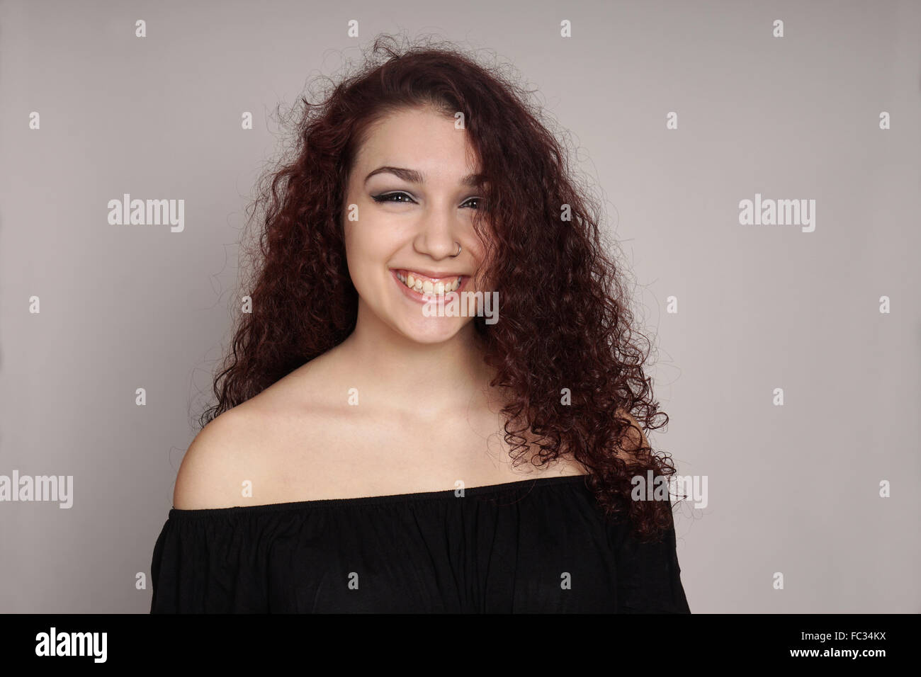 smiling teenage girl with curly hair Stock Photo - Alamy