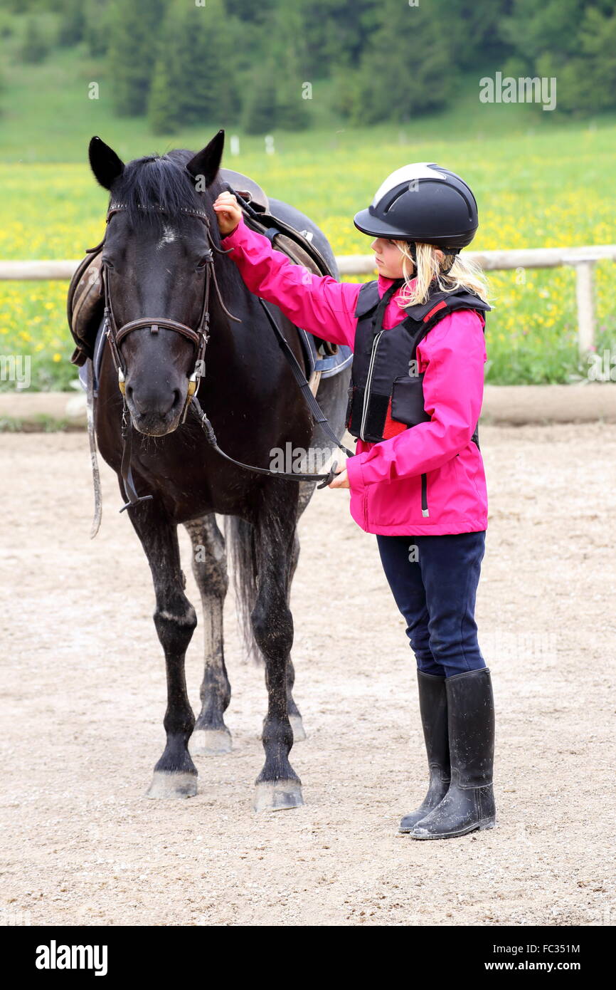 girl and black horse Stock Photo