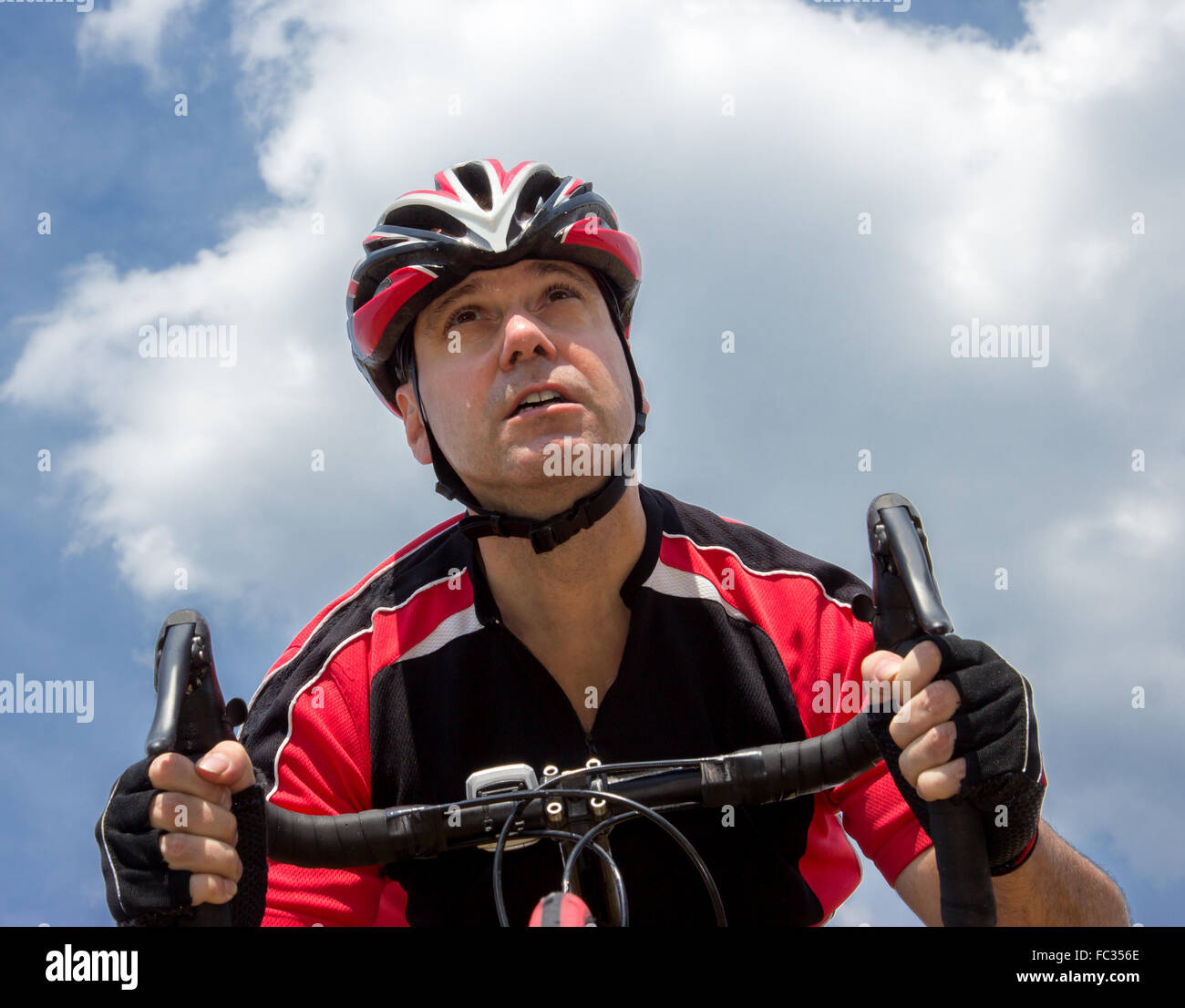 portrait of cyclist at sky background Stock Photo