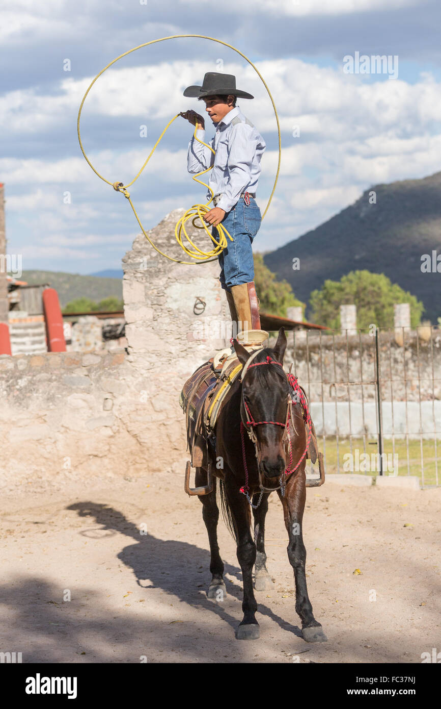 Charro Rodeo Ropes A Mexican charro or cowboy practices roping skills standing on his ...