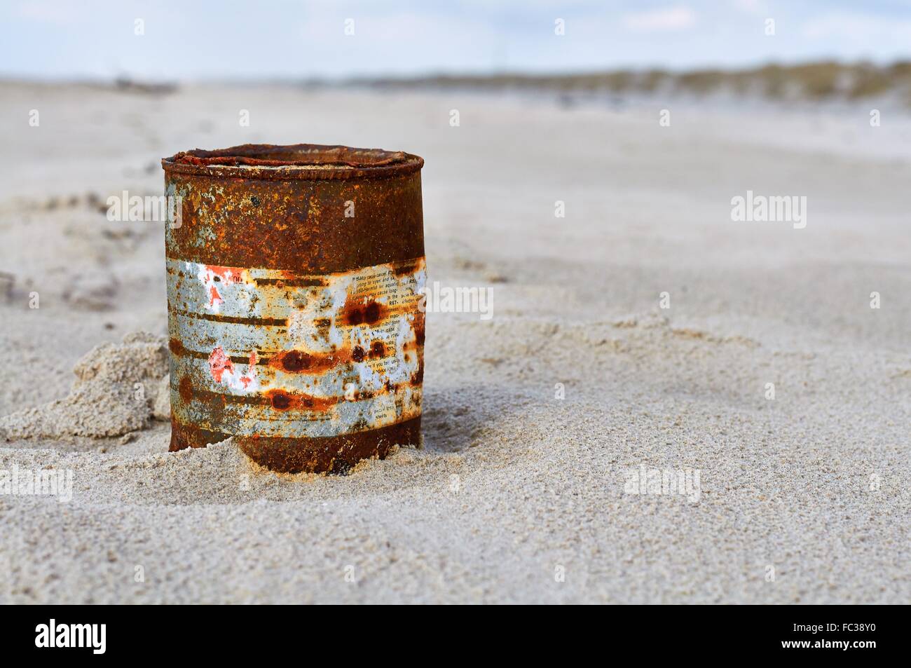 Flotsam: Rusty Tin Can for Chemicals Stock Photo
