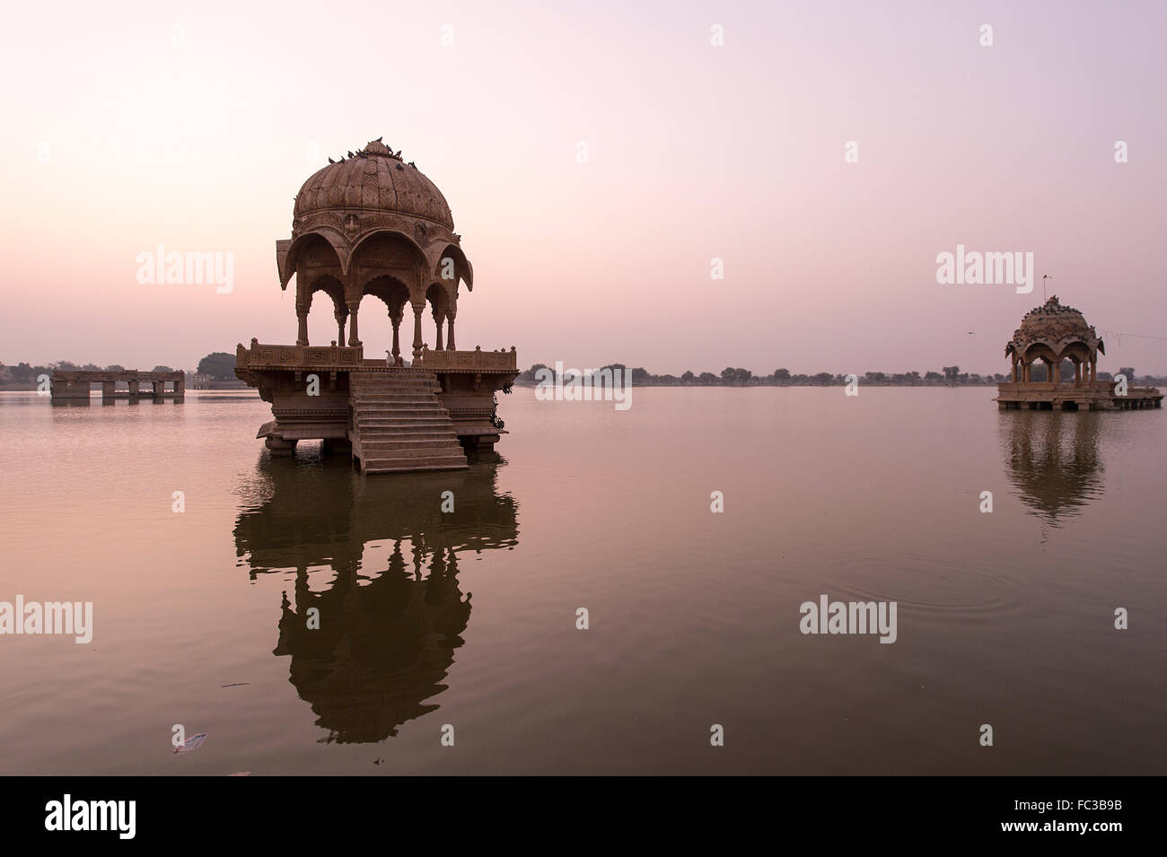Indian landmarks - Gadi Sagar temple on Gadisar lake during sunrise - Jaisalmer, Rajasthan, North India. Stock Photo
