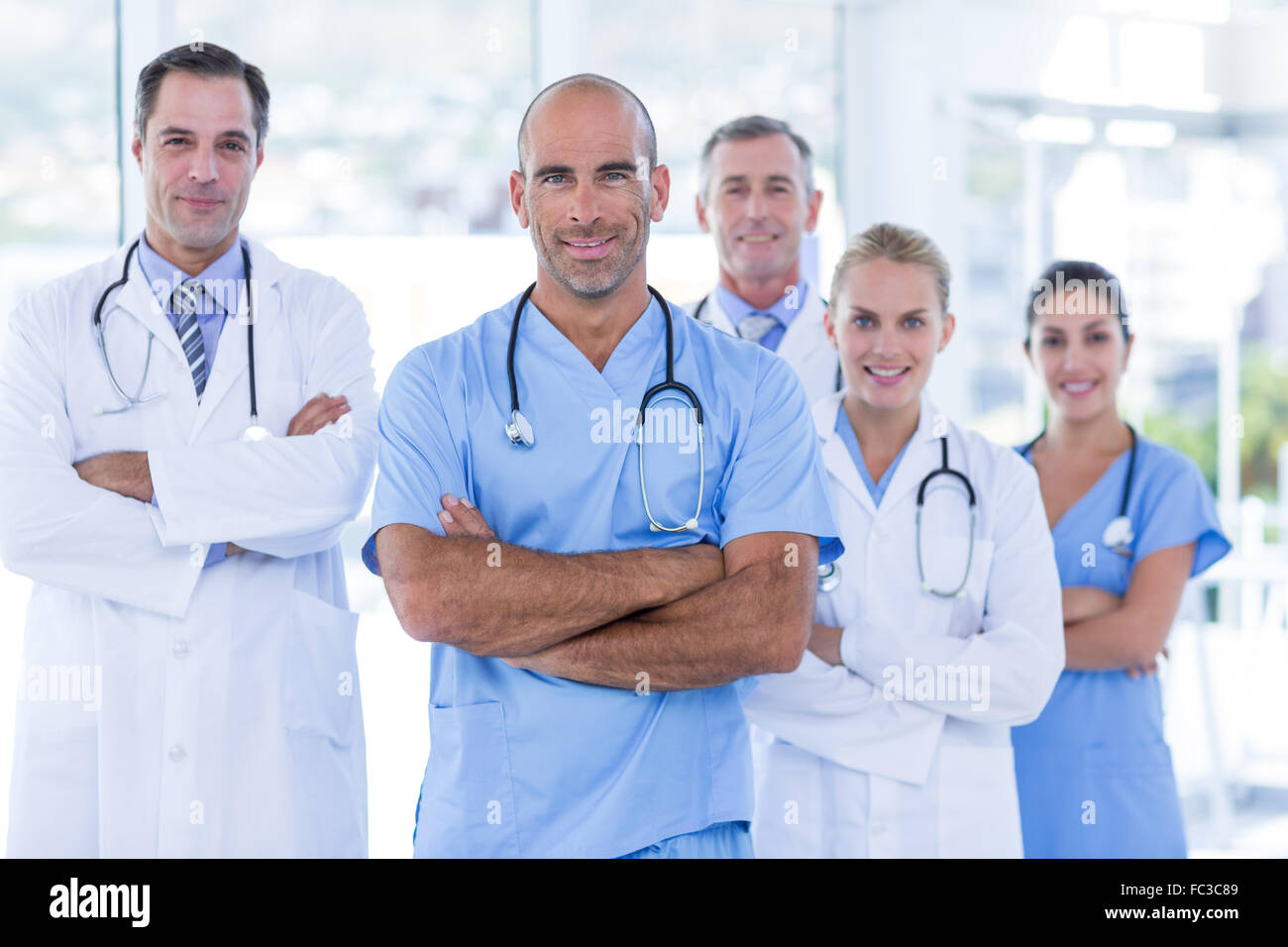 Team of smiling doctors looking at camera with arms crossed Stock Photo ...