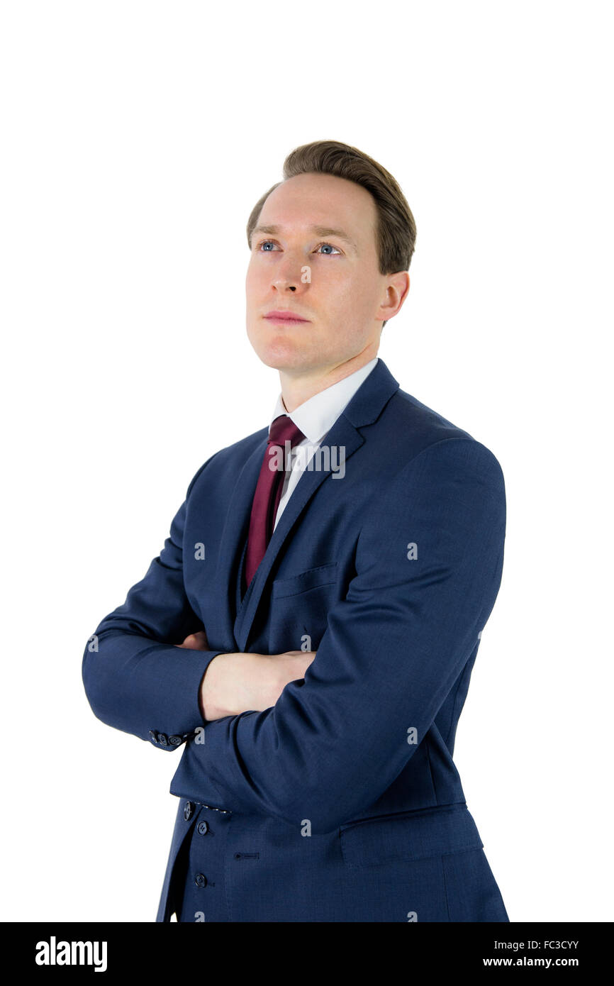 Thoughtful businessman looking away with arms crossed Stock Photo - Alamy