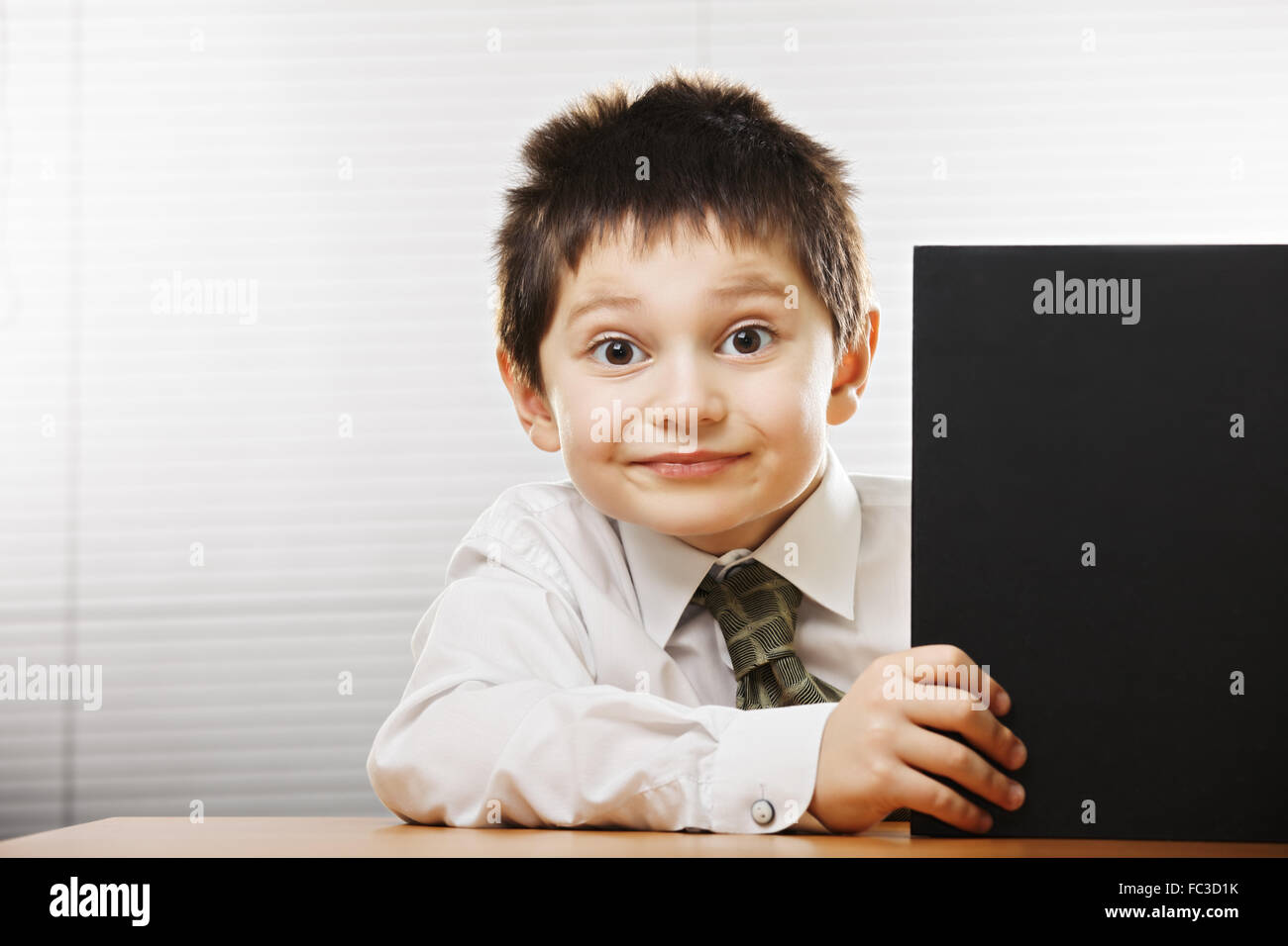 Funny boy looking out of the book Stock Photo Alamy