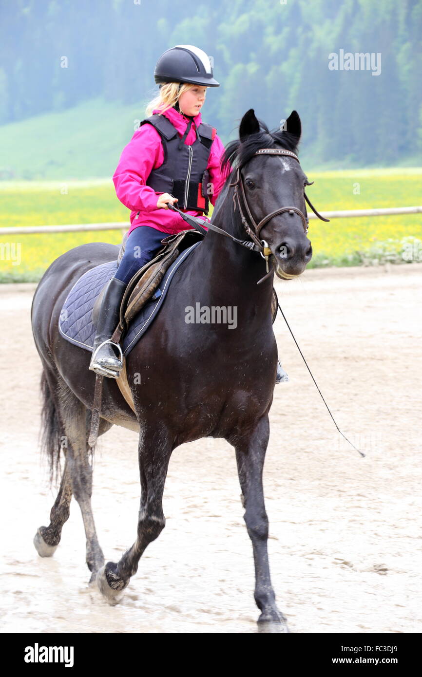 black horse and young girl Stock Photo