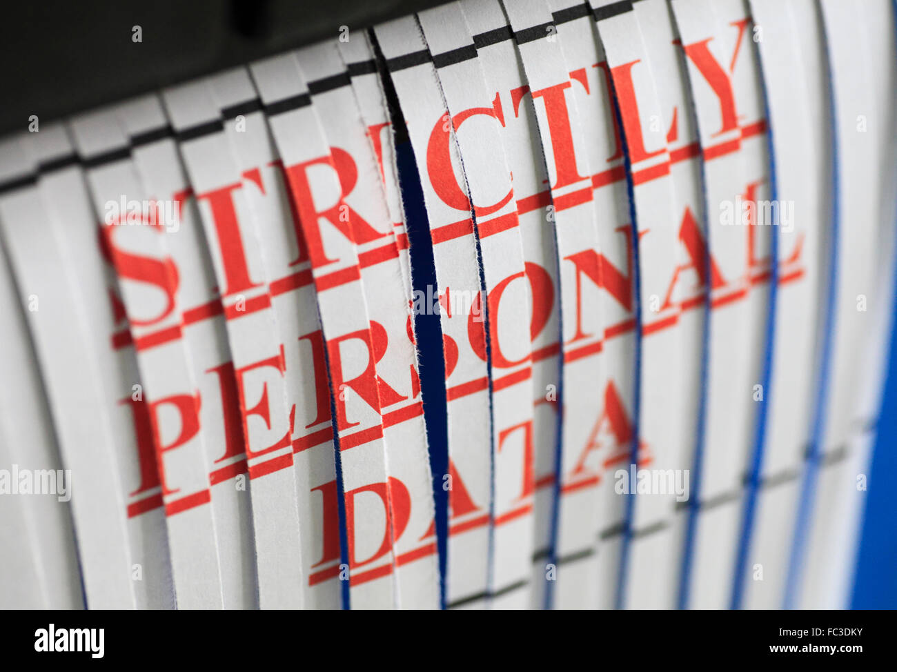 'STRICTLY PERSONAL DATA' paper through a shredder. Stock Photo