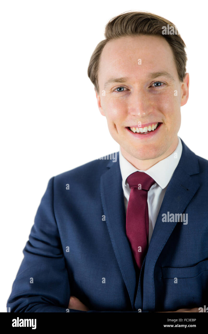 Happy businessman looking at camera with arms crossed Stock Photo - Alamy