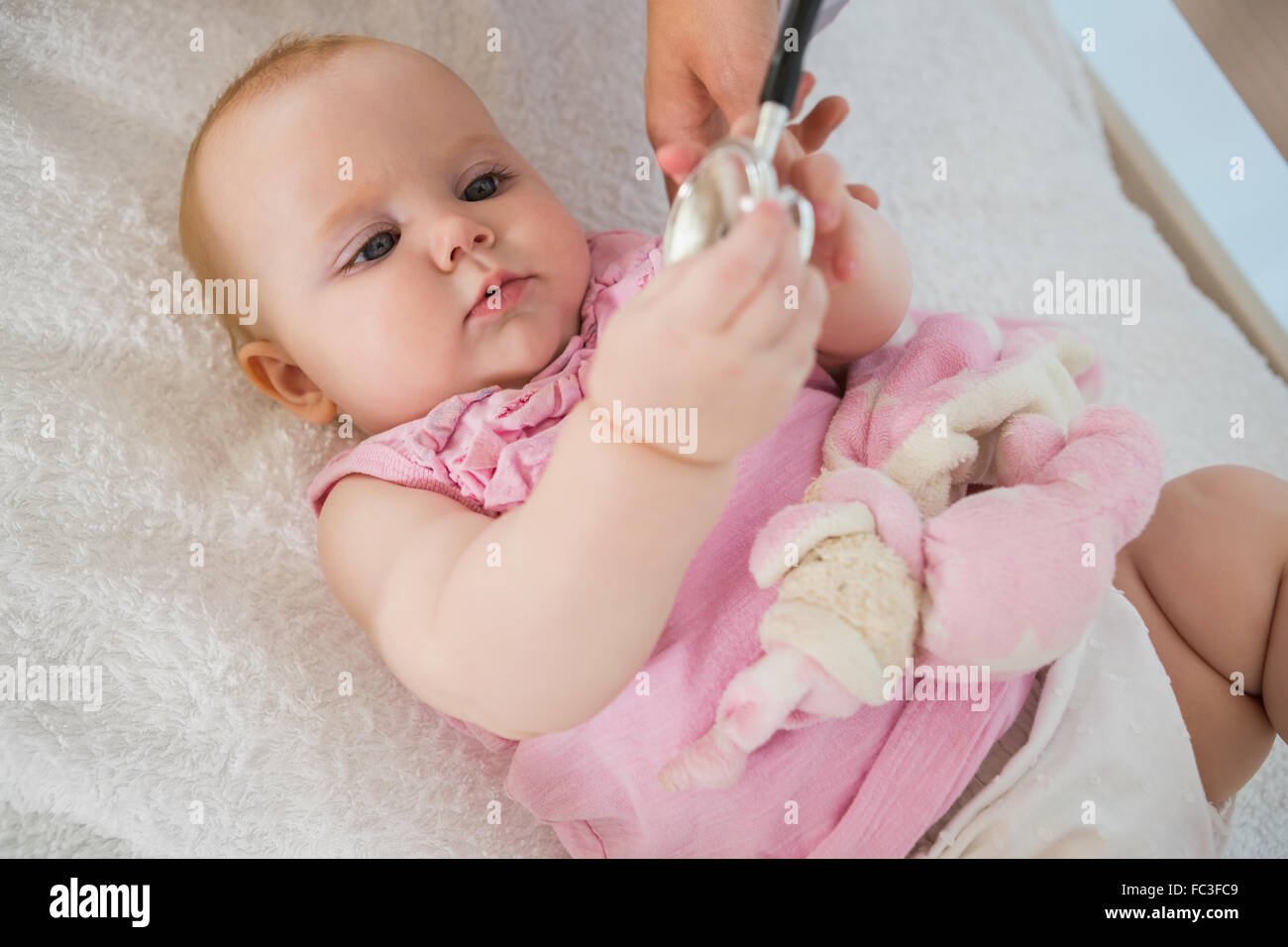 Beautiful cute baby girl with doctor with stethoscope Stock Photo