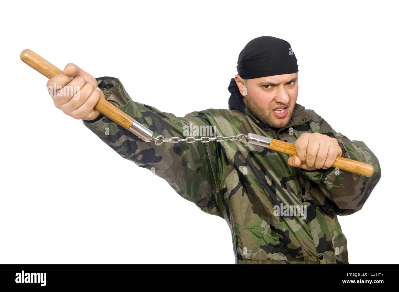 Young man in soldier uniform holding nunchaks isolated on white Stock Photo