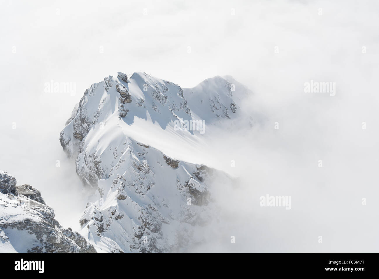 Dachstein Mountains rises above fog carpet Stock Photo