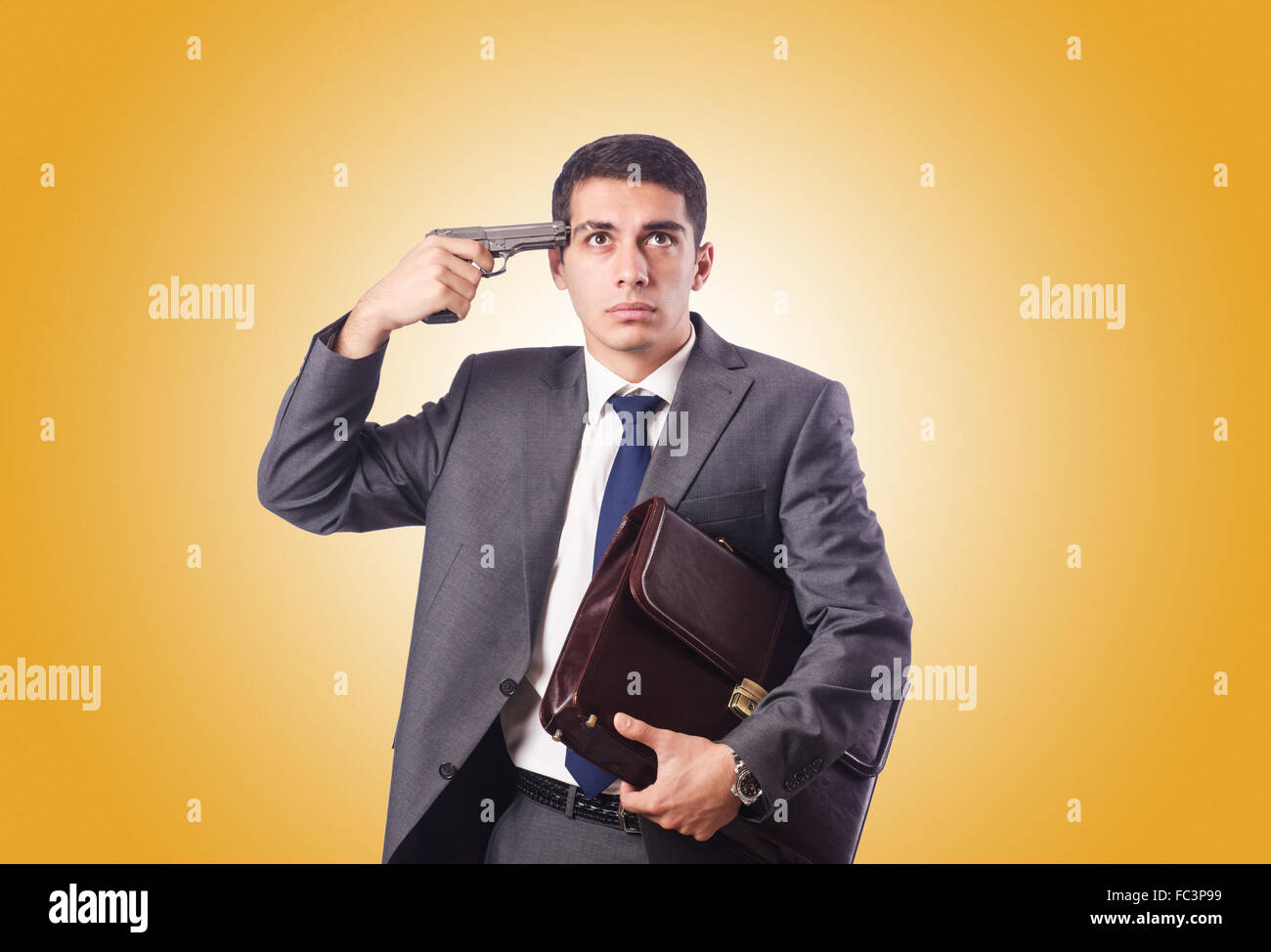 Businessman thinking of suicide against gradient Stock Photo