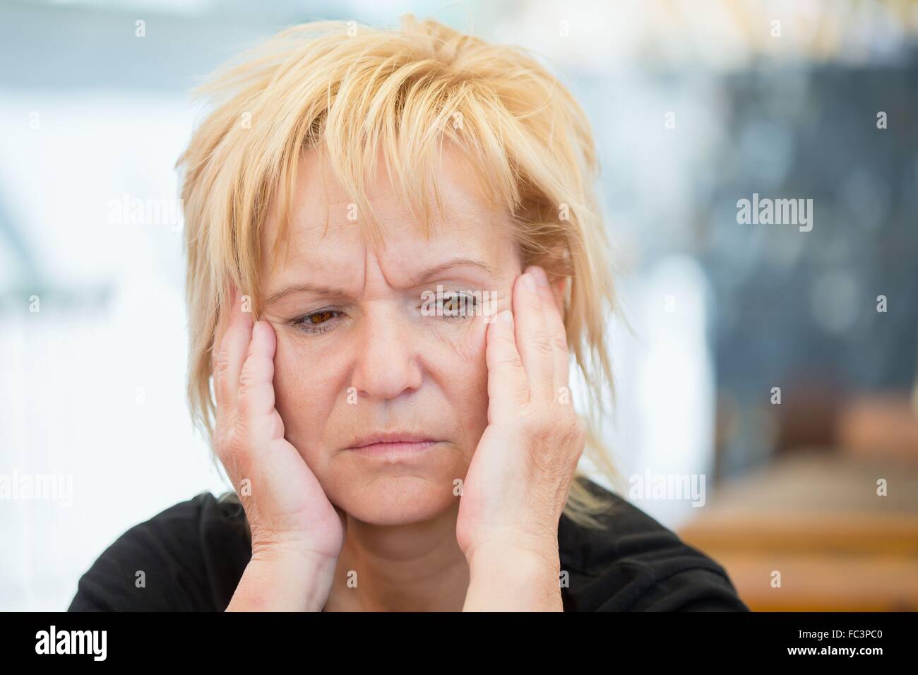 Very worried middle-aged woman Stock Photo