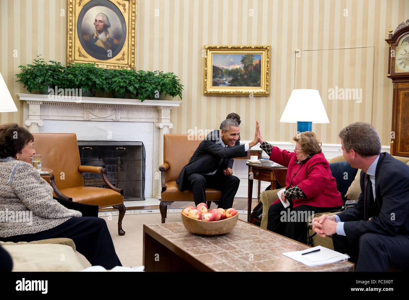 U.S President Barack Obama high-fives Sen. Barbara Mikulski during a meeting with her and Rep. Nita Lowey in the Oval Office of the White Hosue November 3, 2015 in Washington, DC. OMB Director Shaun Donovan looking on from the right. Stock Photo