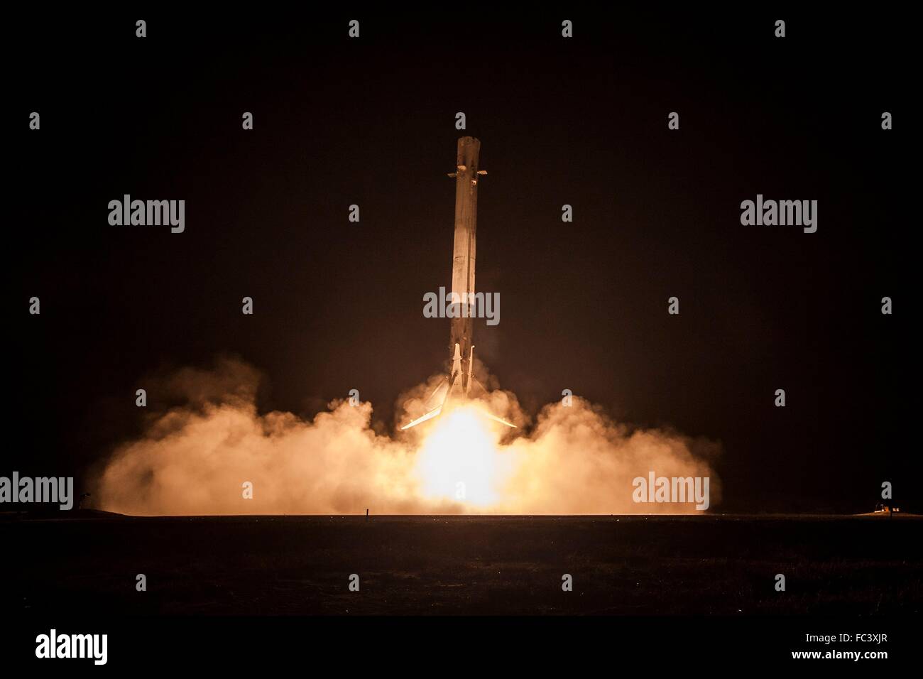 The SpaceX Falcon 9 first stage reusable rocket touches down on Landing Zone One December 21, 2015 in Cape Canaveral, Florida. This was the first successful landing of the reusable first stage rocket in controlled-descent flight following liftoff. Stock Photo