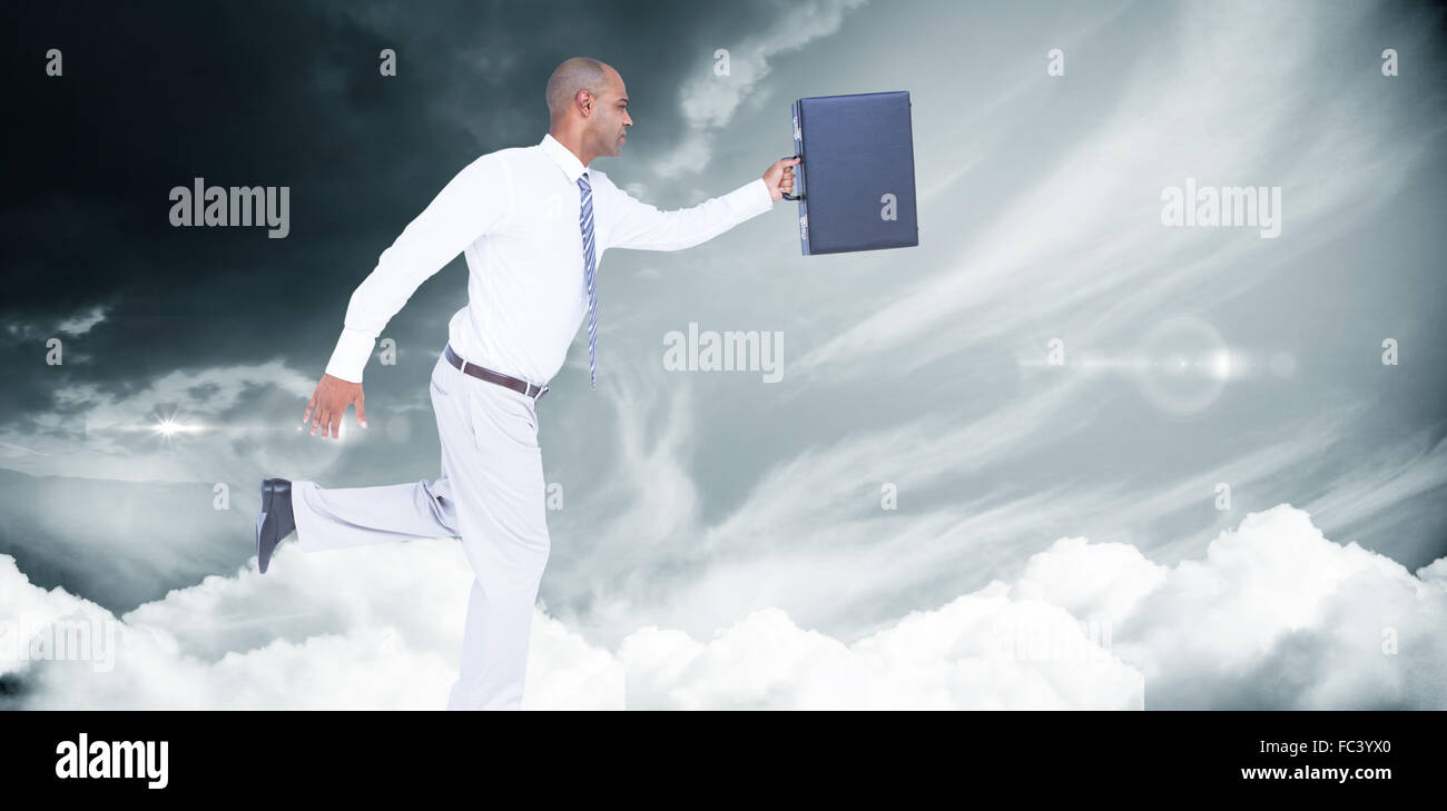 Composite image of businessman running with briefcase Stock Photo - Alamy